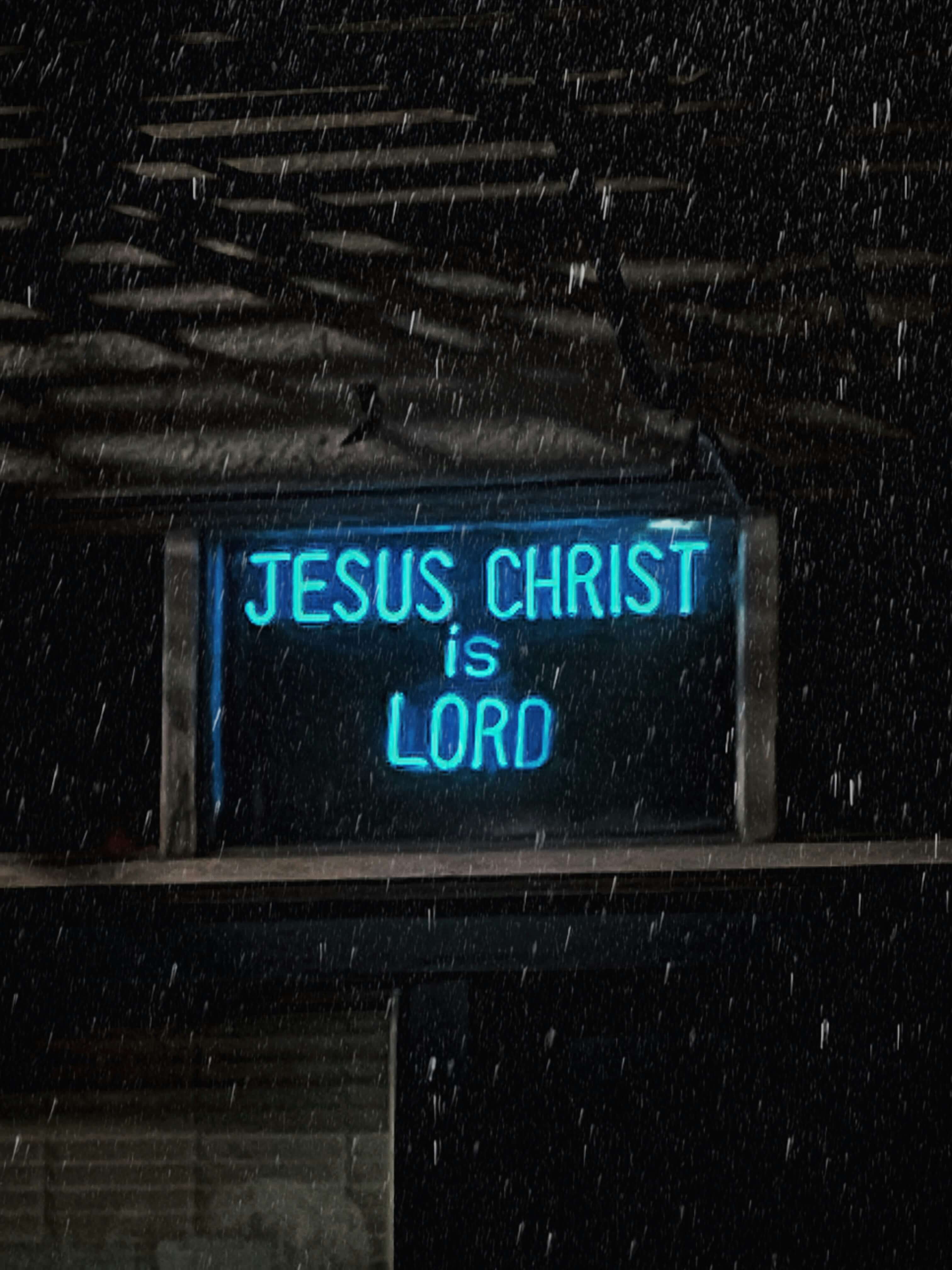 Neon sign with the text 'Jesus Christ is Lord'